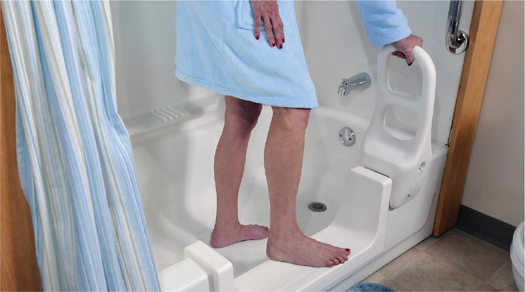 Person holding the 16.5-inch clamp-on Molded Tub Bar for support while stepping into a bathtub