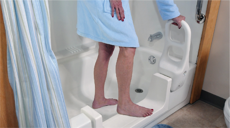 Person holding the 16.5-inch clamp-on Molded Tub Bar for support while stepping into a bathtub