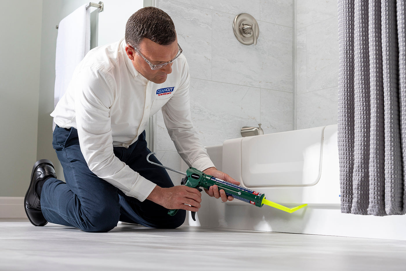 CleanCut installer applying sealant during a bathtub accessibility conversion installation.