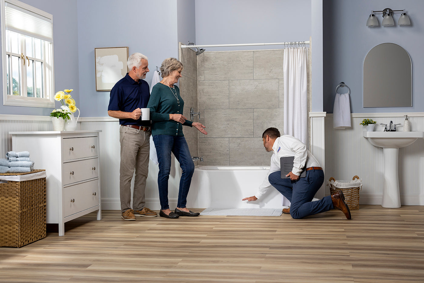 CleanCut installer demonstrating bathtub accessibility modifications to homeowners.