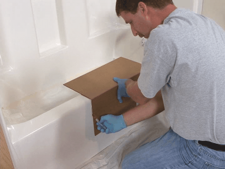 A CleanCut installer tracing the tub cutout location
